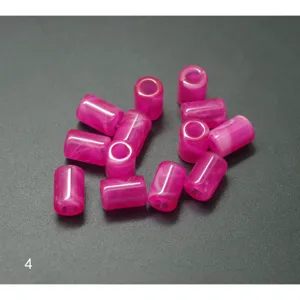 Detailed close-up view of vibrant pink acrylic barrel beads, perfect for DIY jewelry making.