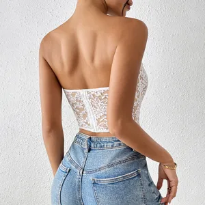 Detailed back view of a sexy white lace strapless crop top paired with classic blue denim jeans.