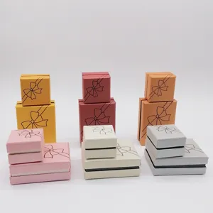 Assorted color paper jewelry gift boxes with bow prints, perfect for ring and earrings detail.