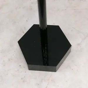Detail shot of the black acrylic T-shaped earring display stand hexagonal base.