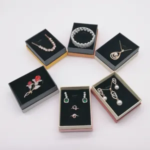 Detailed view of fashion jewelry set featuring necklace rings earrings in display boxes.