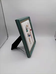 Vintage dark green photo frame jewelry display stand for earrings and necklaces detail.