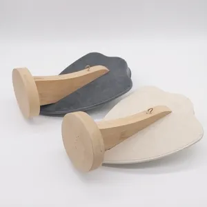 Microfiber and wood necklace display stand detail, premium jewelry holder prop for pendant.