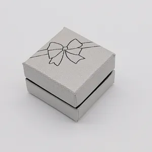 Silver square jewelry gift box with bow print, elegant packaging for rings, earrings and necklaces.