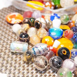 Colorful mixed lampwork glass beads for DIY jewelry making, assorted shapes and sizes.