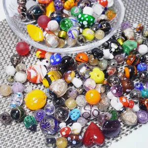Colorful mixed glass beads for DIY jewelry making, assorted shapes and vibrant colors.