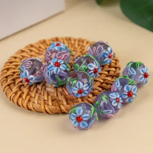 Handmade lampwork glass beads with floral design for DIY bracelets and necklaces.