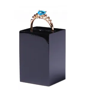Black acrylic ring display stand holder for jewelry showcase and retail counter use.