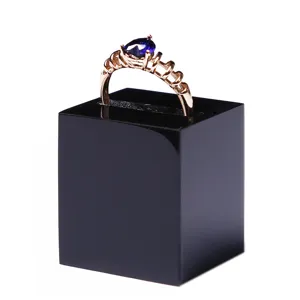 Black acrylic ring display stand holder cube for jewelry retail showcase and store presentation.