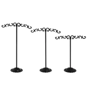Set of 3 black metal earring display stands with decorative base and scroll top for jewelry store retail.