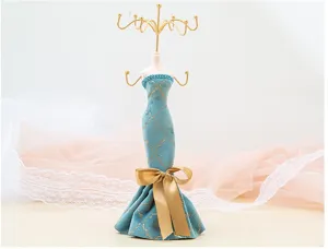 Dress-shaped jewelry display stand detail shot, creative velvet necklace and ring organizer rack.