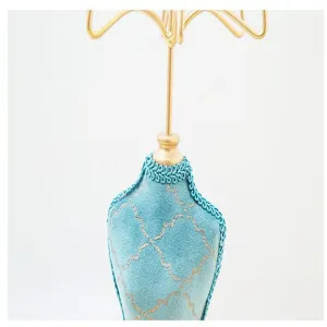 Detailed view of a blue velvet mannequin jewelry display stand with gold metal hooks.