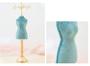 Velvet mannequin jewelry display stand with gold hooks for necklaces and earrings detail.
