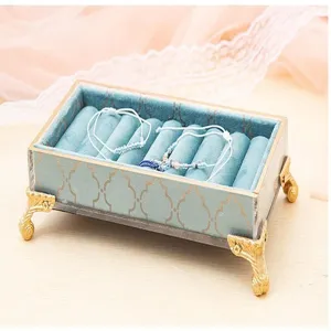 Clear acrylic velvet jewelry box with gold legs, elegant ring storage display case for items.