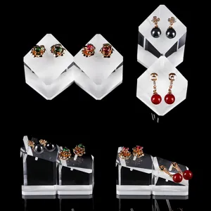 Detailed close-up of acrylic jewelry display stands showcasing various fashion earrings.