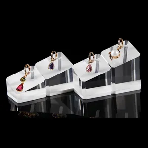Exquisite drop earrings set featuring colorful teardrop gems and pearls on clear stands.
