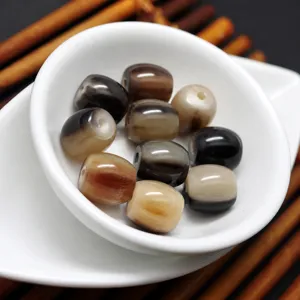 Natural buffalo horn barrel beads detail, smooth surface with unique grain for DIY jewelry.
