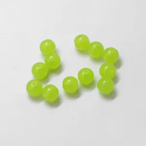Primo piano dettagliato di perline sfuse in acrilico trasparente verde per gioielli.
