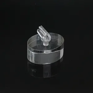 Vue de détail d'un support de bague en acrylique transparent avec clip et base ovale.