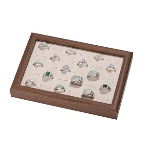 Walnut solid wood ring display tray detail, beige velvet slot insert, jewelry storage prop.