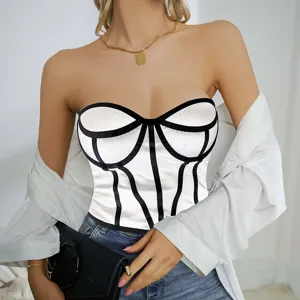 Closeup detail view of a stylish white strapless bustier top with striking black contrast piping.