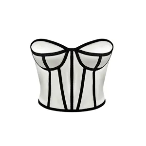 Detail view of the white strapless corset top with black contrast piping and structured underwire cups.