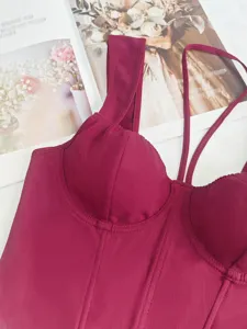 Burgundy corset top detail view, featuring structured boning, sweetheart neckline and slim fit.