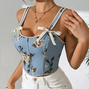 Detalle de cerca del top corsé de jacquard floral azul con elegantes tirantes de lazo blanco.