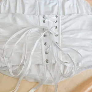 Close-up detail of white lace-up corset top showing metal grommets and silky ribbons texture.