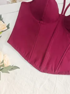 Burgundy corset crop top detail view, showcasing slim fit and boning structure clearly.