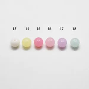 Close up of colorful acrylic jelly round beads with numbers, DIY jewelry making parts.