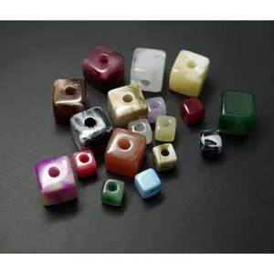 Gros plan de perles carrées colorées en acrylique avec de grands trous pour les bijoux DIY.