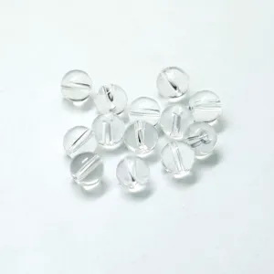 Close-up detail of clear acrylic round drilled loose beads for DIY jewelry making.
