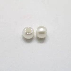 Close-up detail of off-white imitation pearl large hole round bead DIY jewelry accessory.