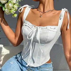 White corset camisole detail showing fishbone structure, tie shoulders and front bow.