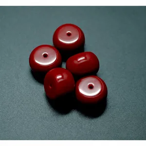 Dark red barrel bead detail, ox blood flat bead DIY jewelry accessory close-up display shot