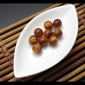 Golden silk sea willow resin loose beads detail shot, DIY bracelet Buddha bead accessories.