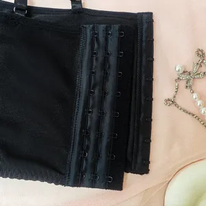 Detailed view of a black multi-hook bra back closure with delicate strap and charms.