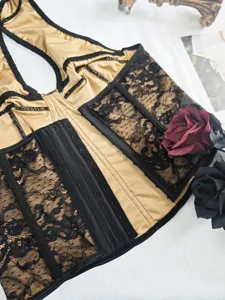 Details of the sexy boned corset with black lace panels, gold satin fabric and hook closure.