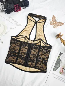Black lace halter corset top detail, showing floral jacquard texture and boning for retro style.