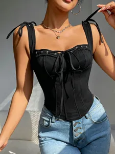 Close-up detail of the black corset camisole featuring front bow tie and metal eyelet accents.