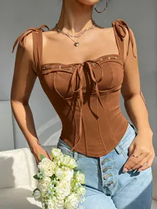 Brown corset crop top with tie straps and lace-up front detail, stylish summer wear.