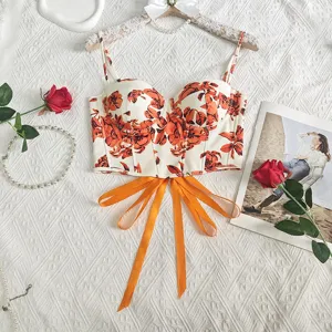 Stunning floral cropped bustier top featuring boning structure and chic orange ribbon straps.