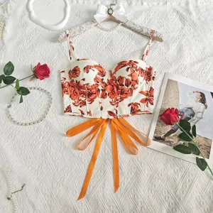 Detailed view of vintage floral corset top with spaghetti straps and orange bow string.
