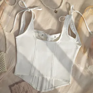 White corset camisole with bow straps and fishbone boning for a stylish and sexy look.