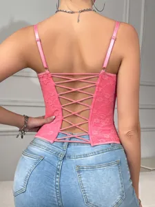 Pink lace corset top detail view, featuring cross back straps and sexy backless design.
