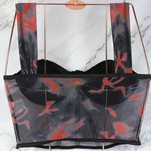 Detailed shot of women's mesh printed strappy corset crop top with underwire and boning.