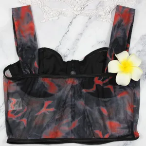 Detail shot of red and black mesh tie-dye crop top with underwire and boning support.