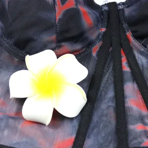 Detailed view of women mesh printed boned camisole top featuring floral decoration.