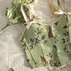 Vista detallada del top corsé de jacquard floral verde vintage con bonitos lazos.